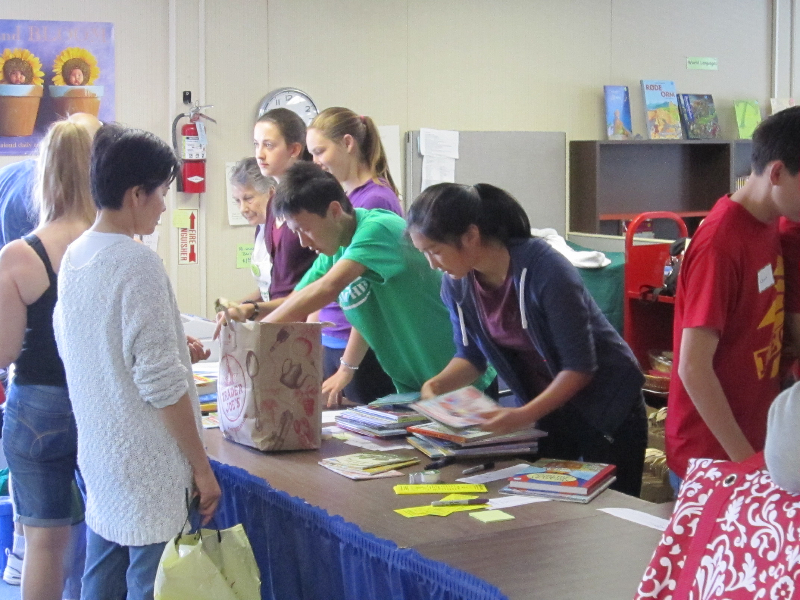 Teen volunteers working as cashiers in the Children\'s Room